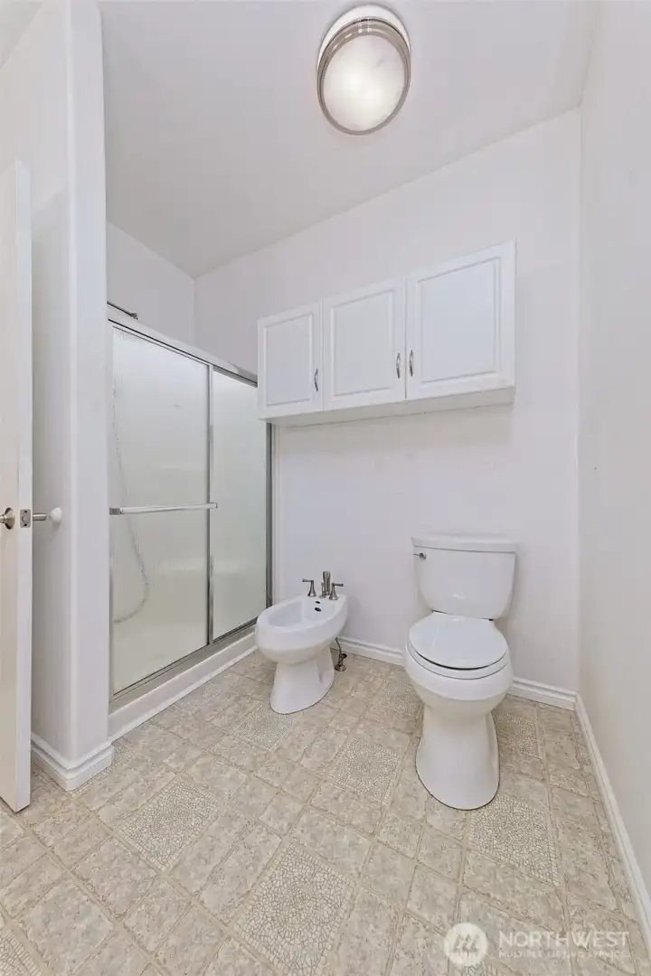 Primary bathroom with step-in shower in addition to the claw-foot tub. And a BIDET!