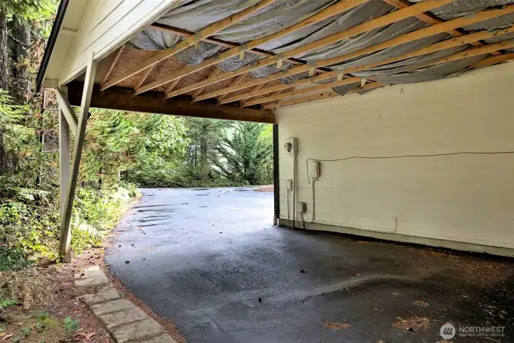 Carport adjacent to the huge shop. Additional covered storage.