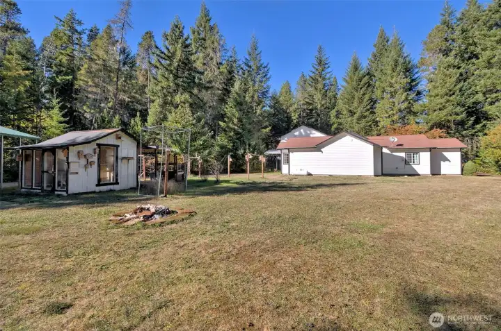 Beautiful flat, fully-usable acre. Cool little work shop to the left.