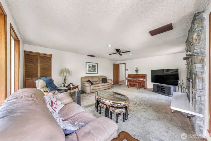 Second living room on main floor, this one with a fireplace.