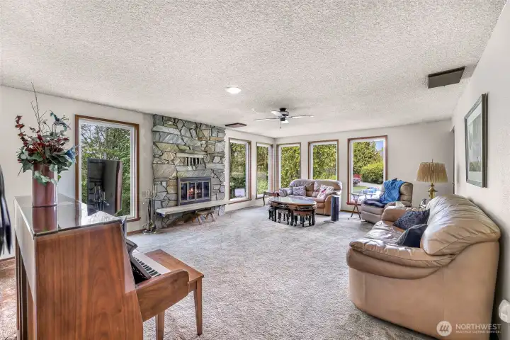 Second living room on main floor, this one with a fireplace.