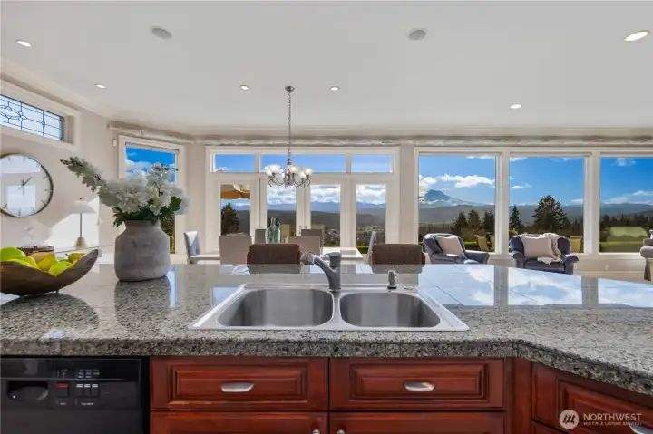 Rich granite surfaces, expansive island and custom cabinetry
