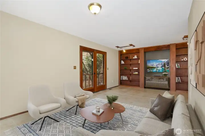 Family rm showing french doors and entertainment shelving.