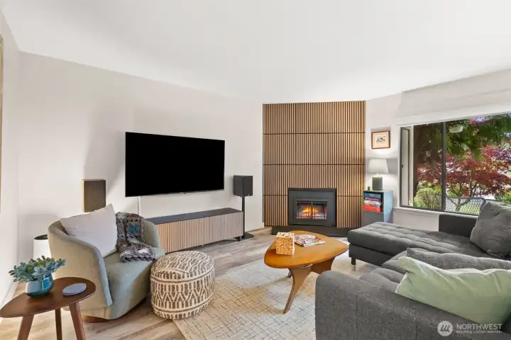 Wow - this living room is just right off the pages of Dwell magazine. Brand new electric fireplace with modern custom panelling gives this entire room a face lift.