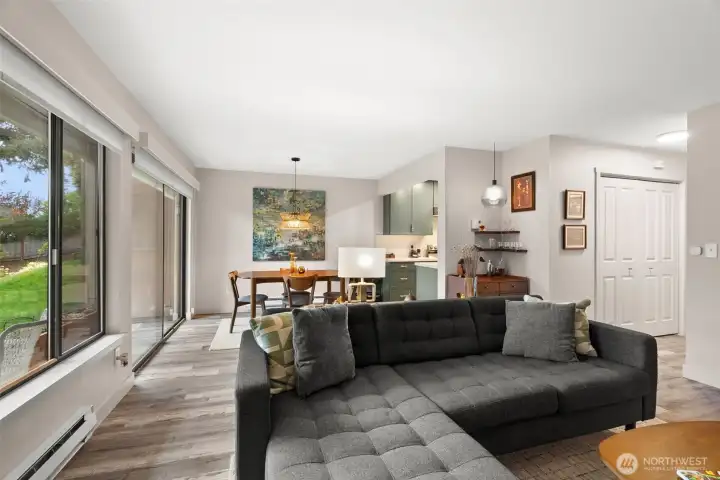 Open living room looking at dining area and kitchen with tons of natural daylight.