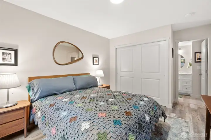 Primary bedroom with large closet and access to bathroom.