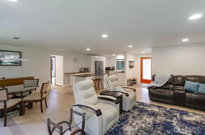 View looking back towards the front door.  Open concept kitchen with modern flair.