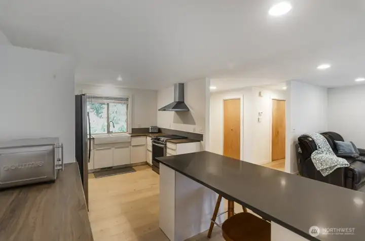 Upgraded range hood plus new high end induction stove.  This view shows the entry, complete with coat closet.