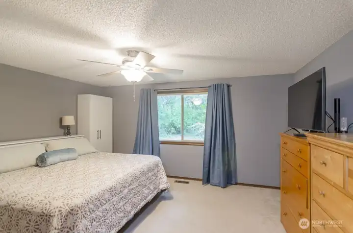Private primary suite overlooks back yard.
