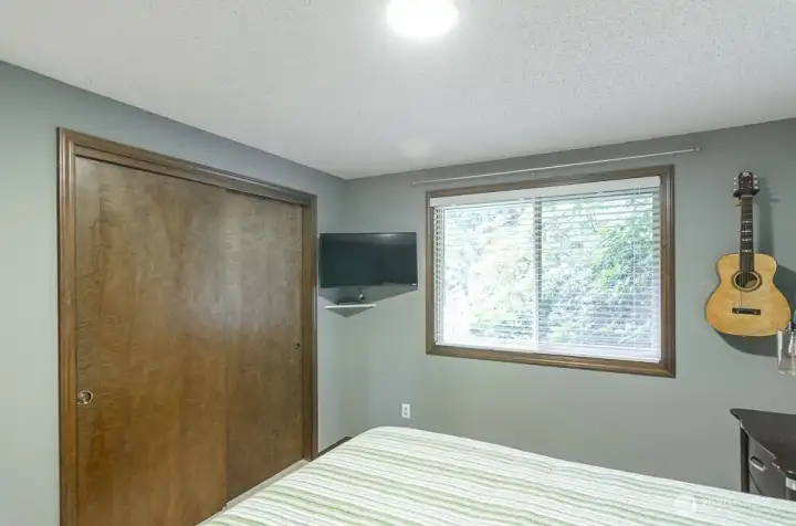 Another view.  Small TV stays with the home.   Wood wrapped windows and window treatments are throughout the home.