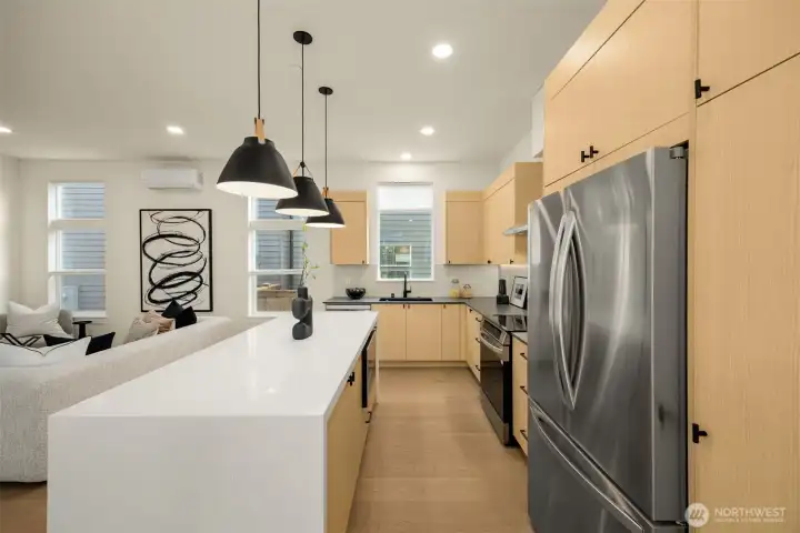 Chef's kitchen opens to the living and dining areas.