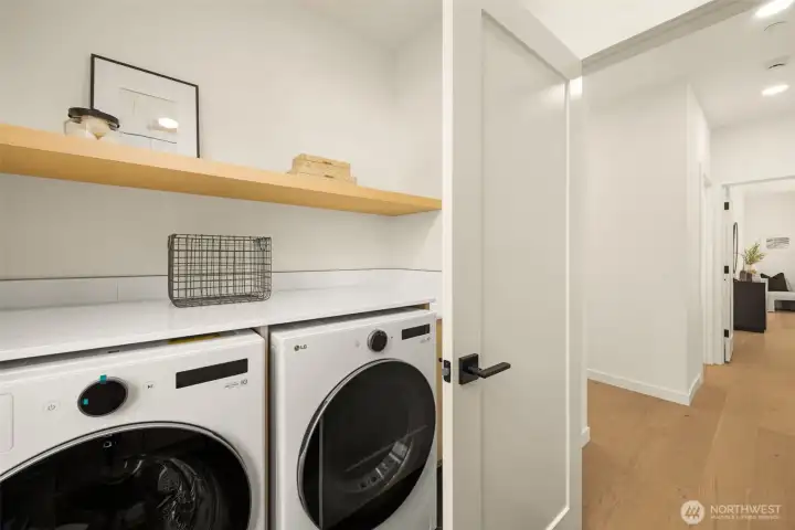 Convenient upper level laundry room with washer and dryer.
