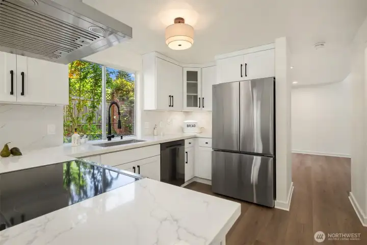 Beautifully updated kitchen with crisp white cabinetry that offers timeless appeal.