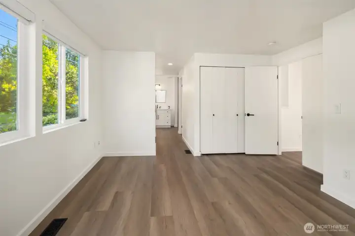 Well-designed and light-filled primary suite layout with a closet, separate walk-in closet, and private bath.