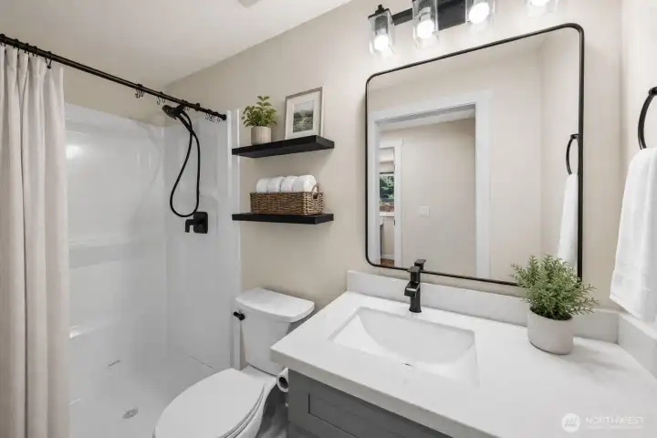 The second bathroom has a small footprint but is large on convenience,