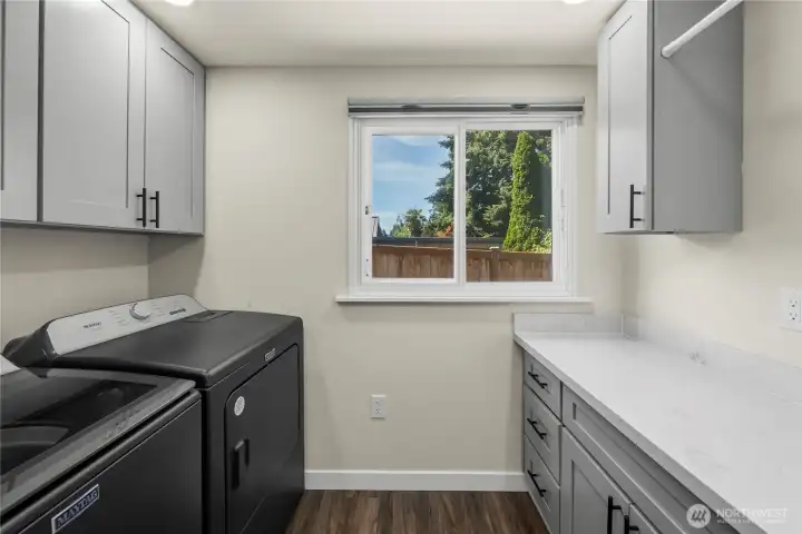 The laundry room is well equipped with counter space and built-ins or closet space.
