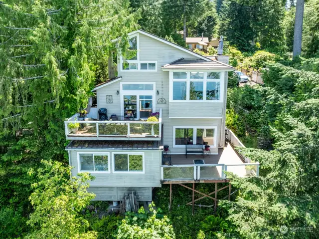 Drone photo of back of home which faces the canal and Olympic Mts.