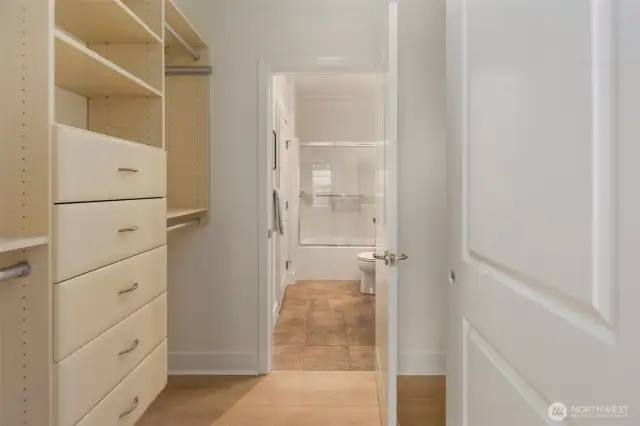 Pass through primary closet with added custom closet system.