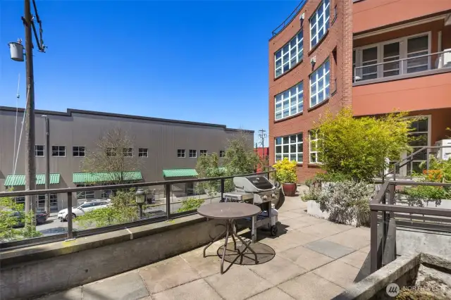 Courtyard with umbrella seating & BBQ gril.