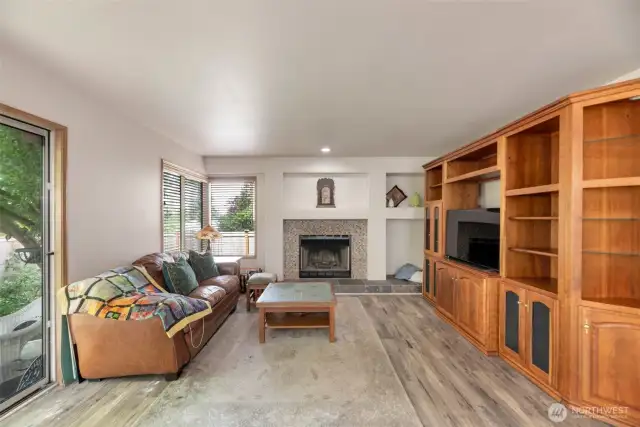 Family room with gas fireplace (hutch on right does not convey). Access to private backyard