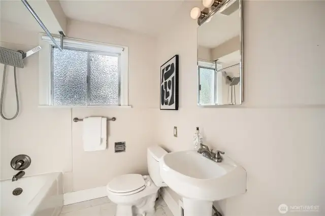 Upper level Bath is modernized while respecting the era of the home.