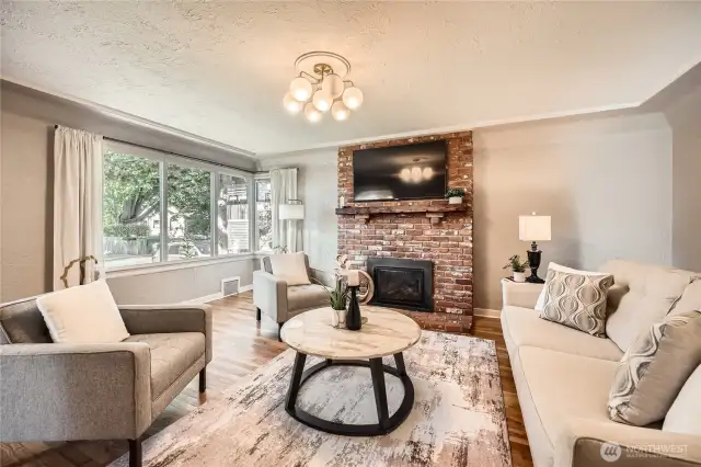Picture windows that wrap around the corner bring abundant natural light into your Living Room.