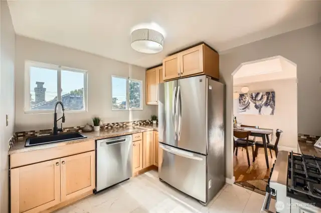 Wood cabinets and stainless steel appliances in this cook's Kitchen.