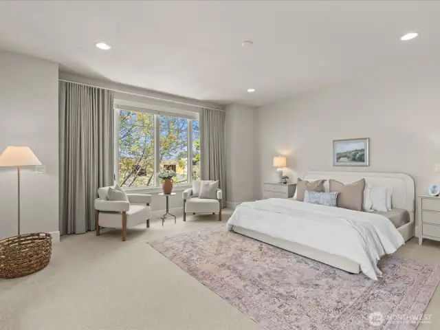 Enter your grand-sized primary bedroom, featuring a cozy sitting area, blackout drapes with up-down shades for customizable light control, and a stunning two-sided gas fireplace that adds warmth and ambiance.