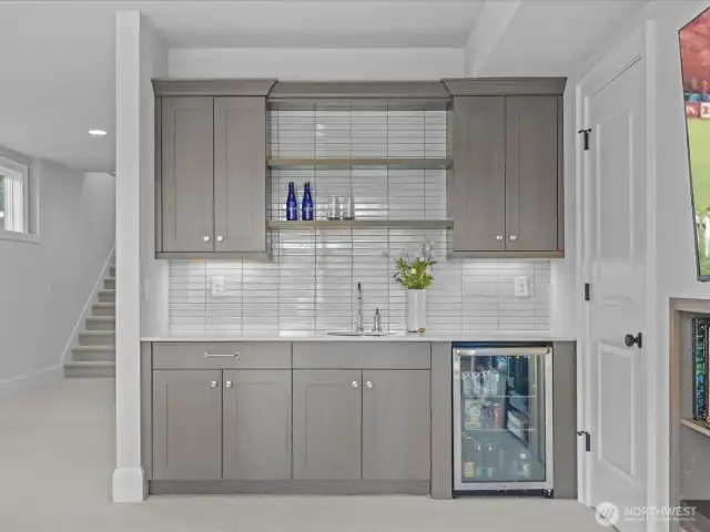 A sumptuous wet bar adds to the lower-level experience, complete with a Frigidaire beverage refrigerator—ideal for entertaining and effortless refreshment.