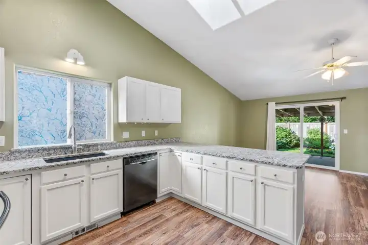 Notice the tall ceiling and skylights in this room.