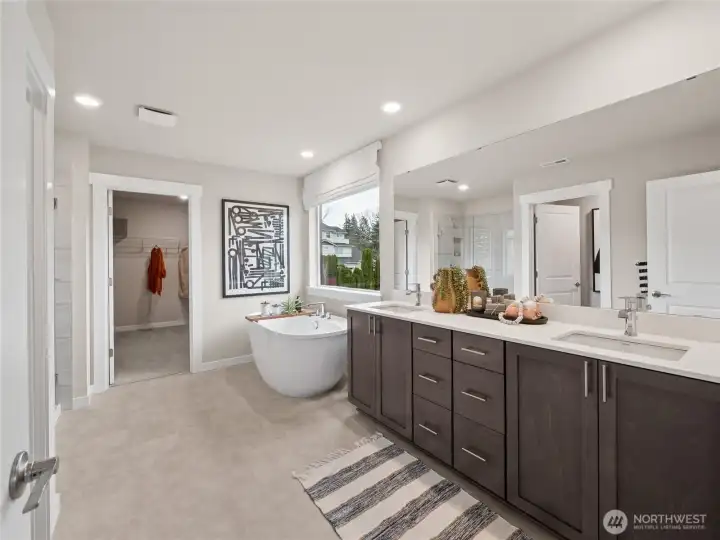 5-piece primary bath with soaker tub, double vanity, and designer shower. Photo is representational. Actual home is under construction and finishes and paint colors may vary. See site agent for details.