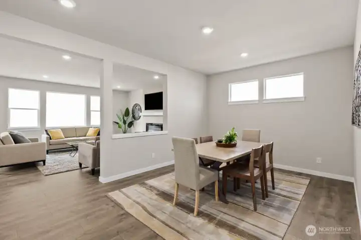 Formal dining room perfect for hosting. Photo is representational. Actual home is under construction and finishes and paint colors may vary. See site agent for details.