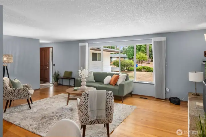 Hardwood flooring in living, dining, bedrooms, and underneath carpet in hallway.