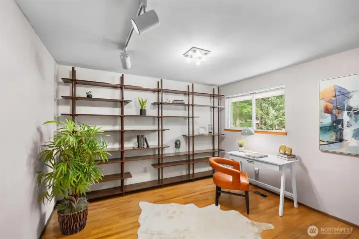 Just one of the four spacious bedrooms with hardwood flooring.