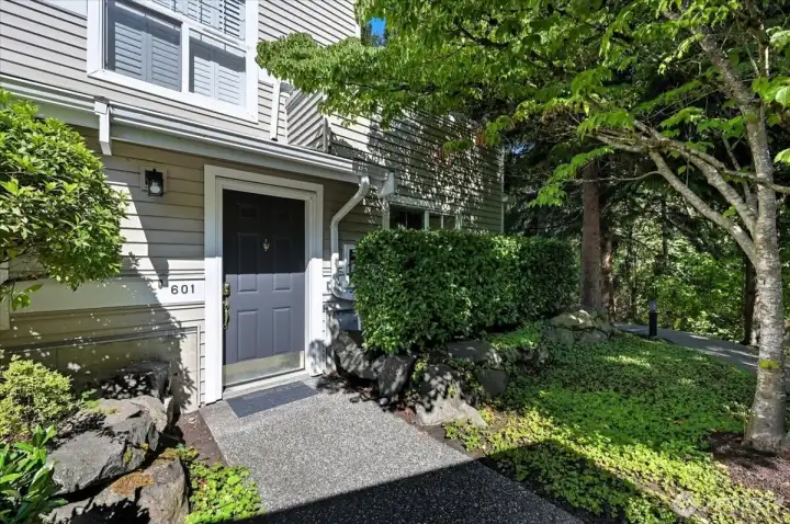 Front entry, ground level adjacent to open wooded space
