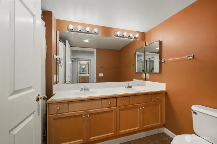 Primary Bathroom with tile countertops and flooring
