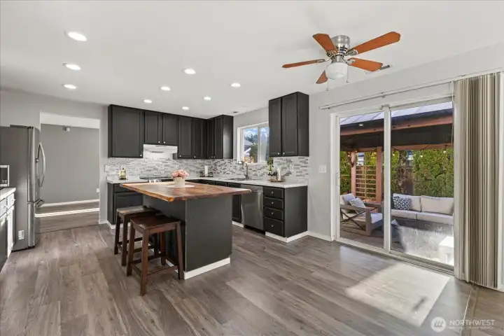 The kitchen has a layout that flows effortlessly with room for seating at the island and enough room for a dining table!