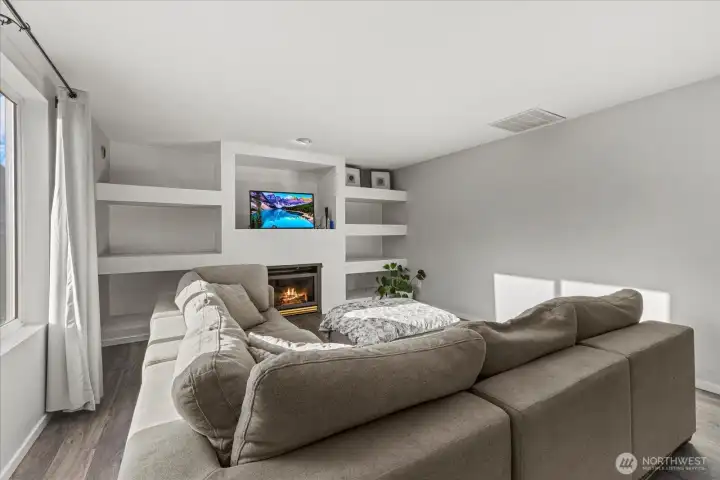 Make the space cozy with sectional and relax by the fireplace!