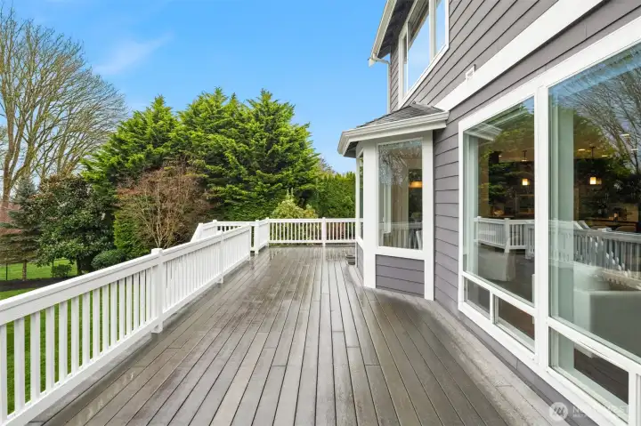 Large composite back deck overlooking beautifully landscaped yard