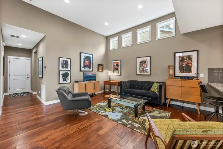 The spacious, open floor plan features vaulted ceilings, & beautiful engineered hardwood flooring