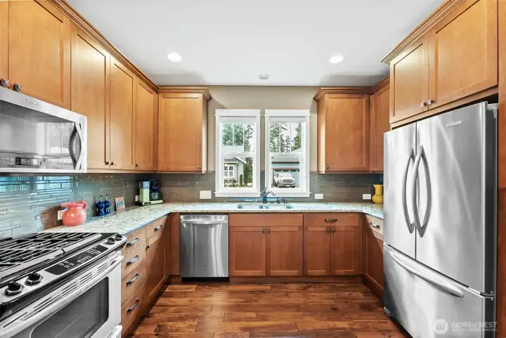 This former Model Home has so many upgrades: 42" cabinetry, Quartz counters & a full height backsplash.