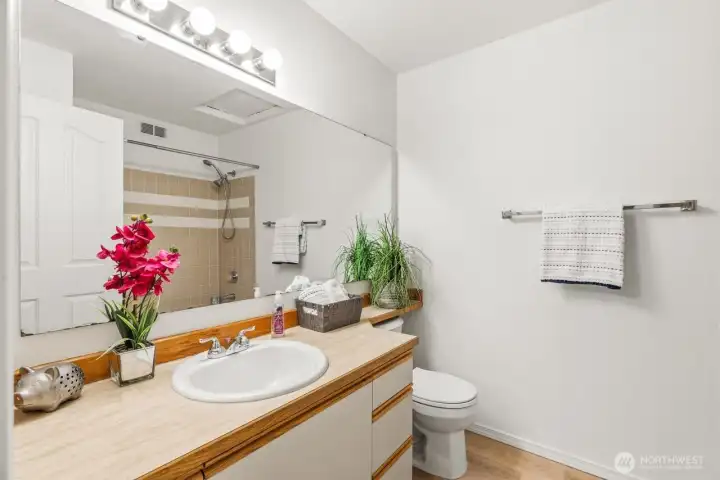 Main bath has lots of cabinets and storage.