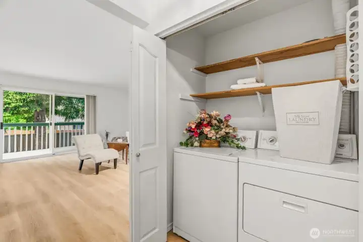 Full size washer and dryer with shelving.