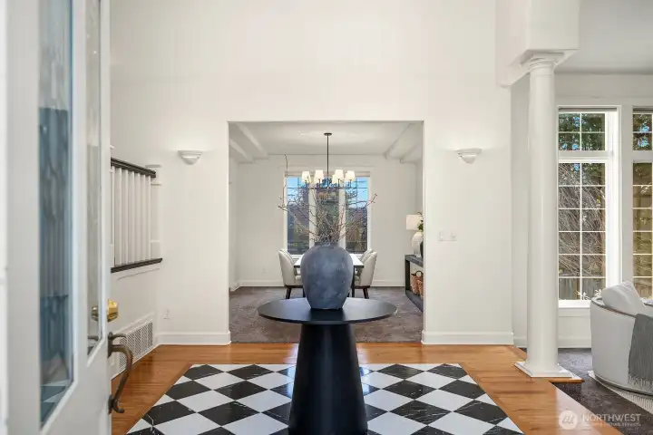 A striking grand entry makes an unforgettable first impression with a soaring chandelier, classic black and white tile flooring, elegant columns, and built-in cabinetry, setting a tone of timeless sophistication throughout this exceptional home. A striking grand entry makes an unforgettable first impression with a soaring chandelier, classic black and white tile flooring, elegant columns, and built-in cabinetry, setting a tone of timeless sophistication throughout this exceptional home.