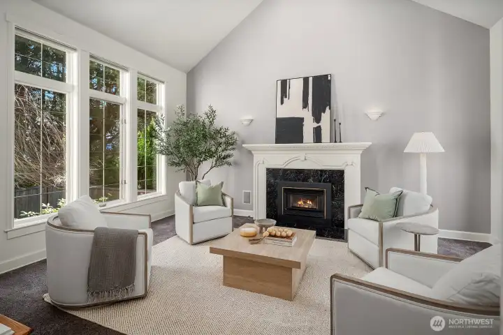Soaring vaulted ceilings, a cozy fireplace, and an abundance of natural light pouring through large windows create a warm and inviting formal living room, an elegant yet comfortable space perfect for both relaxing and entertaining. Soaring vaulted ceilings, a cozy fireplace, and an abundance of natural light pouring through large windows create a warm and inviting formal living room, an elegant yet comfortable space perfect for both relaxing and entertaining.