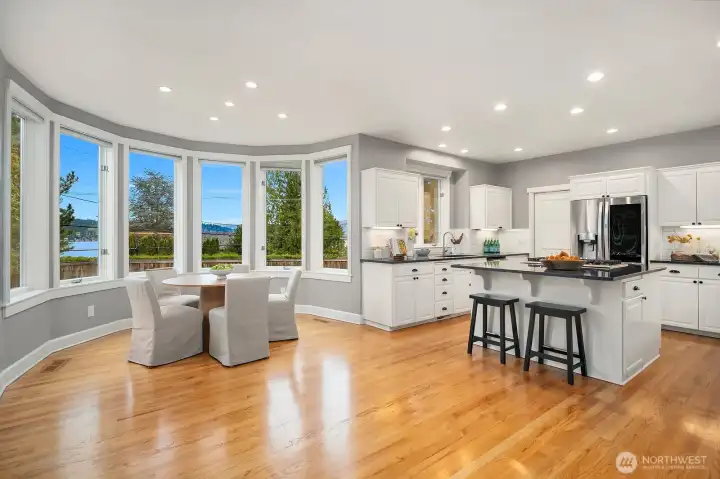 A breathtaking wall of curved windows frames spectacular Lake Sammamish views, flooding this stunning open-concept kitchen and living space with natural light, an extraordinary setting that elevates every moment of daily living and entertaining. A breathtaking wall of curved windows frames spectacular Lake Sammamish views, flooding this stunning open-concept kitchen and living space with natural light, an extraordinary setting that elevates every moment of daily living and entertaining.