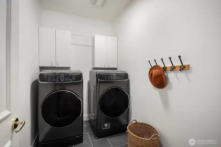 A well-appointed laundry room features a premium full-size washer and dryer with ample surrounding space, a practical and functional amenity that adds everyday convenience to this exceptional Lake Sammamish residence. A well-appointed laundry room features a premium full-size washer and dryer with ample surrounding space, a practical and functional amenity that adds everyday convenience to this exceptional Lake Sammamish residence.