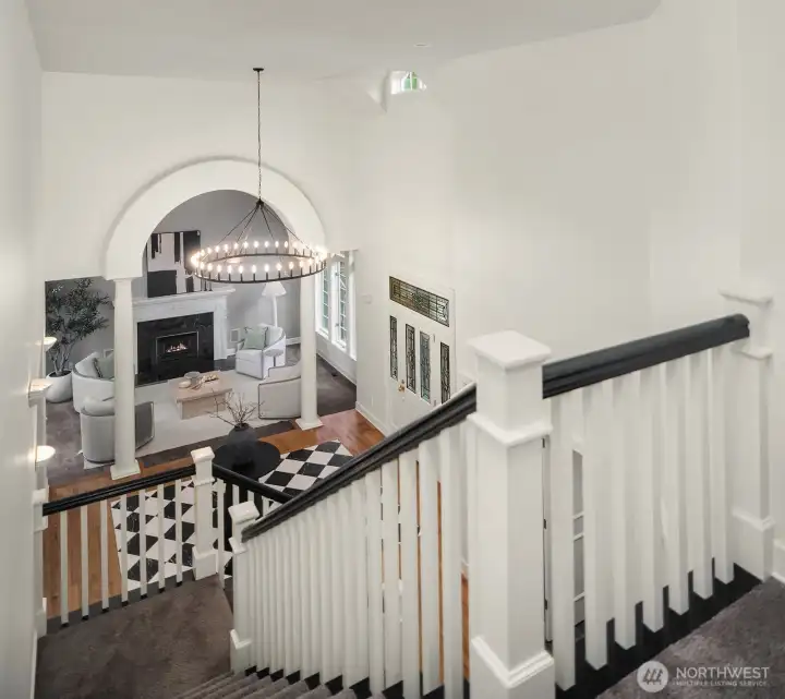 The elegant upper level landing overlooks the grand entry below, showcasing the home's impressive chandelier, soaring ceilings, and beautifully crafted staircase railings, a stunning architectural moment that connects both levels with timeless style. The elegant upper level landing overlooks the grand entry below, showcasing the home's impressive chandelier, soaring ceilings, and beautifully crafted staircase railings, a stunning architectural moment that connects both levels with timeless style.