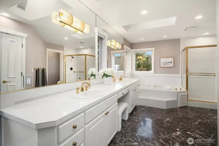 The beautifully remodeled 5-piece primary bath impresses with dual vanities, elegant marble countertops, a soaking tub, and a spacious walk-in shower, a luxurious and spa-inspired retreat thoughtfully designed for everyday indulgence. The beautifully remodeled 5-piece primary bath impresses with dual vanities, elegant marble countertops, a soaking tub, and a spacious walk-in shower, a luxurious and spa-inspired retreat thoughtfully designed for everyday indulgence.