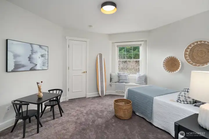 This bright and inviting guest bedroom features plush carpeting, large windows that fill the space with natural light, and a cozy sitting area, perfect for accommodating guests in comfort and style. This bright and inviting guest bedroom features plush carpeting, large windows that fill the space with natural light, and a cozy sitting area, perfect for accommodating guests in comfort and style.